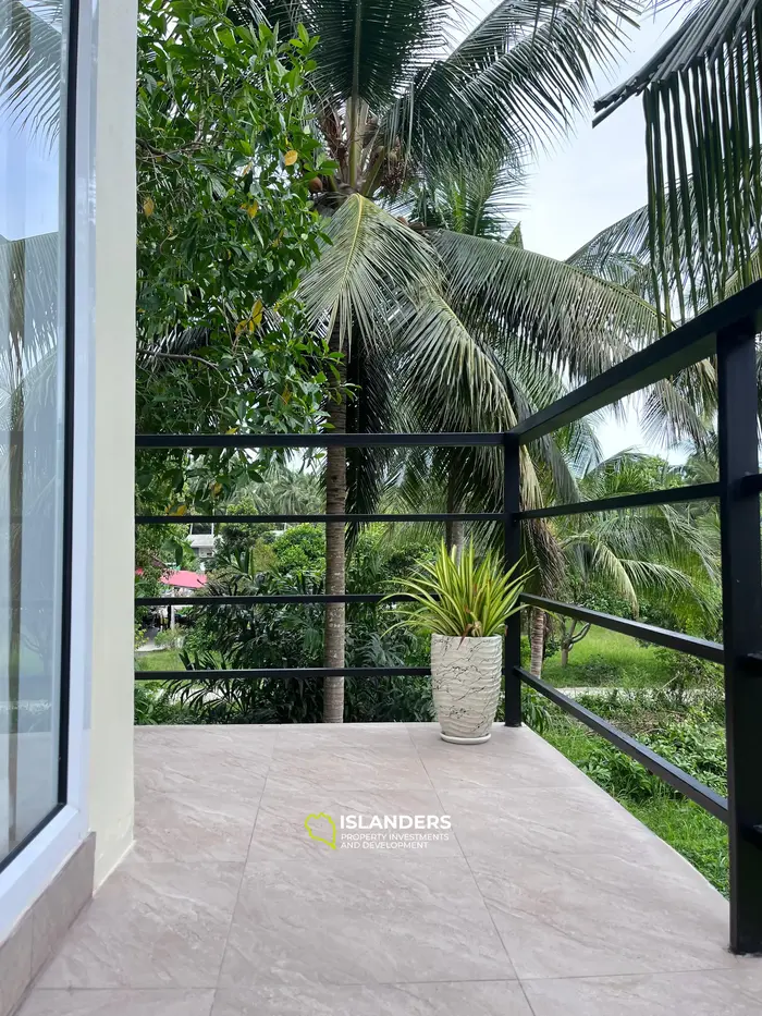 Casa moderna de dos plantas en un entorno tropical verde